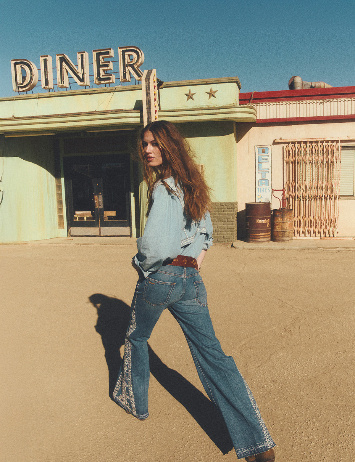 Woman wearing flare blue jeans and an blue blouse